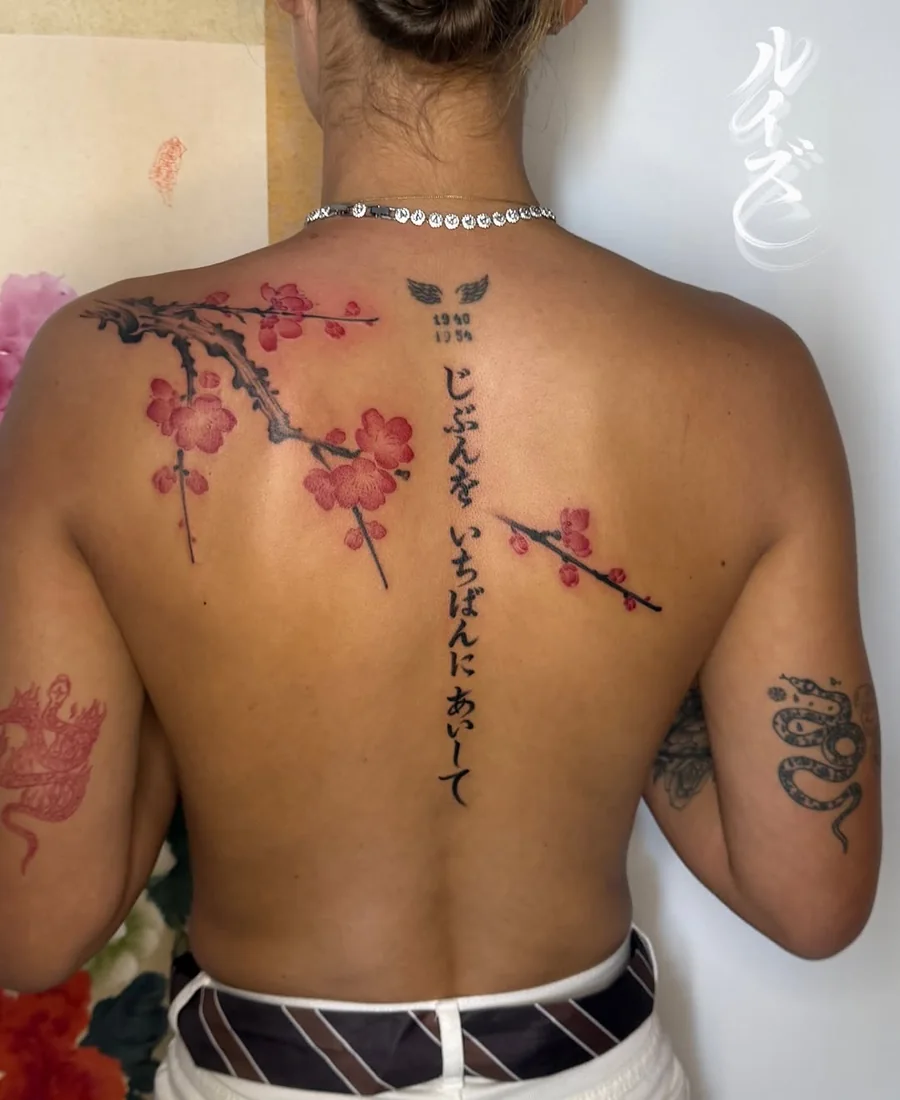 Cherry blossom branches and vertical lettering across the upper back by Luise (Lulu)