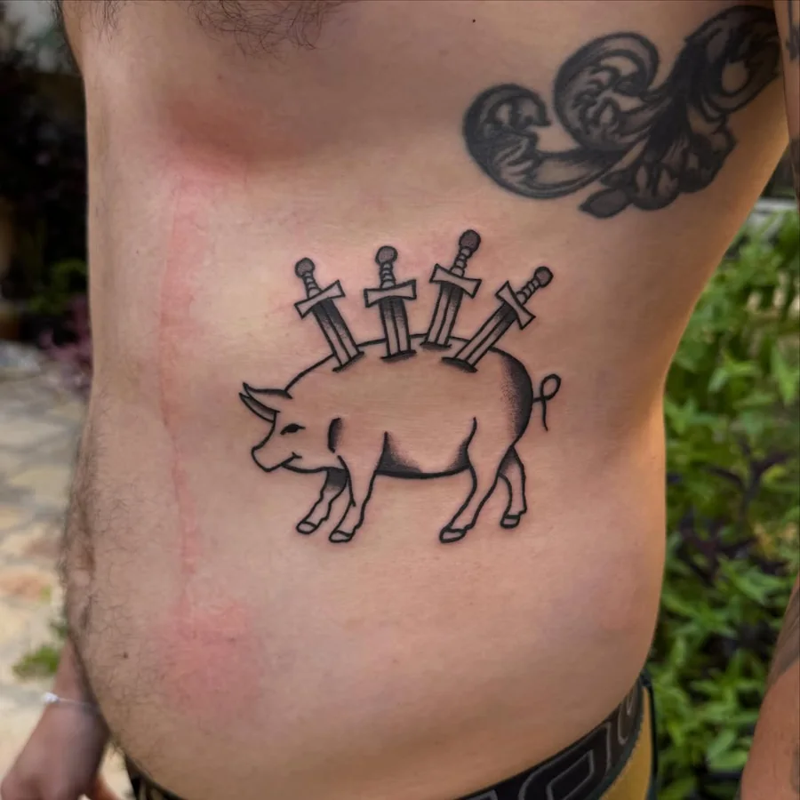 A whimsical pig pierced by three swords, drawn in black linework on the ribs.