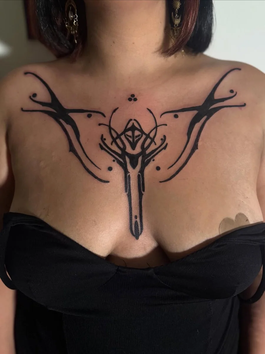 Symmetrical tribal blackwork tattoo across the chest by Yonatan